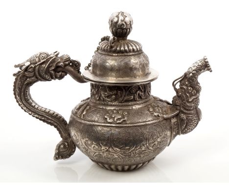 Interesting Tibetan silver teapot of small proportions, with chased and engraved foliate decoration, the spout in the form of