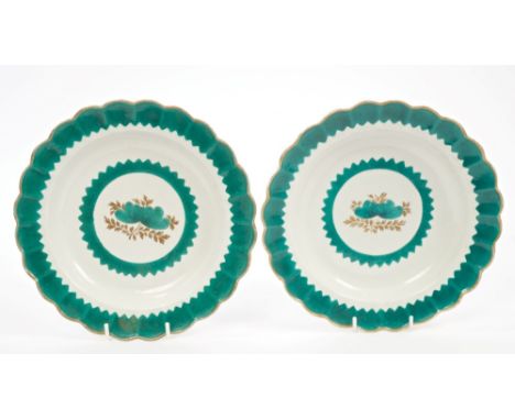 Pair 18th century Worcester green and gilt plates painted with central flower with fluted borders, circa 1780, 21cm diameter