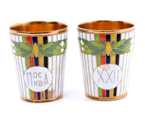 Pair Russian gilt metal and brightly coloured enamel vodka cups commemorating Moscow Olympics, 5cm overall height