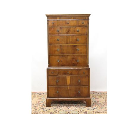 Queen Anne revival yew wood chest on chest of diminutive size, having three short over four long graduated drawers between re