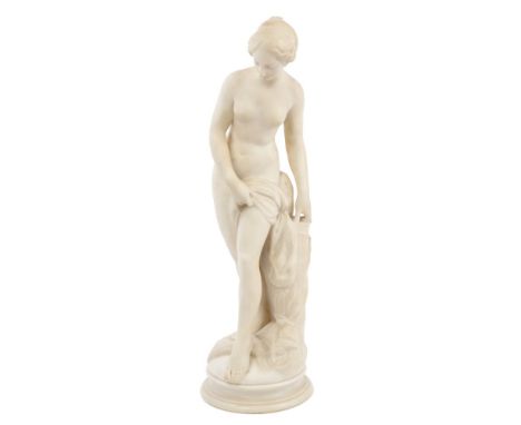 Fine quality 19th century carved white marble statue of Venus bathing, her hair tied up in plaits, standing beside a tree tru