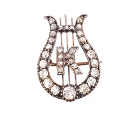 Victorian diamond brooch in the form of a lyre, applied with initial K, set with old cut and rose cut diamonds, in silver and