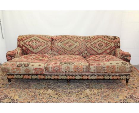 George Smith Kelim upholstered deep three seater sofa in the Howards style, raised on turned legs and castors CONDITION REPOR