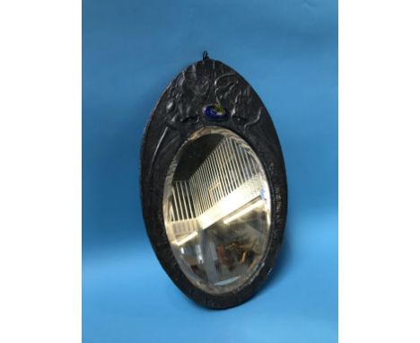 An Art Nouveau oval pewter mirror, inset with coloured enamel cabochon, 37 x 24cm