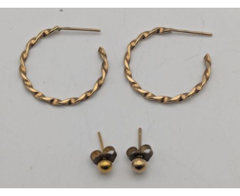 A pair of 9ct yellow gold half hoop earrings and a 9ct stud earring with gold plated back, together with a yellow metal earri