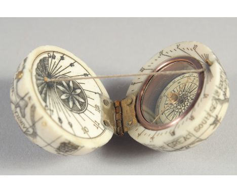 AN ETCHED BONE COMPASS. 1.5ins diameter.