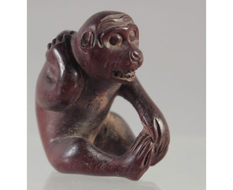 A CARVED WOOD NETSUKE, MONKEY. Signed.