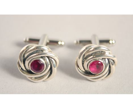 A PAIR OF SILVER RUBY KNOT CUFF LINKS.