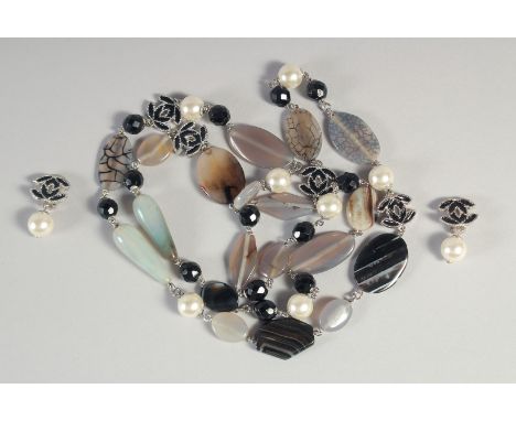 A GOOD LONG CHANEL NECKLACE AND MATCHING EARRINGS with pearl, enamel double C and jewels.