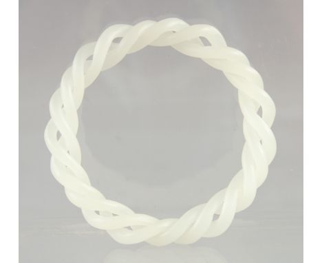 A WHITE JADE DOUBLE TWIST BANGLE. 3ins diameter.