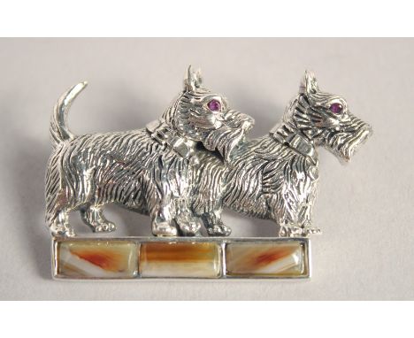 A SILVER AGATE AND RUBY EYE SCOTTIE DOG BROOCH.