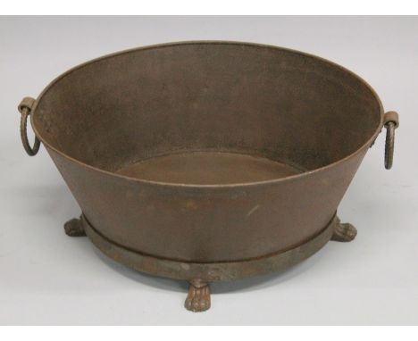 AN OVAL WROUGHT IRON TROUGH OR PLANTER with ring handles. 2ft 6ins long.