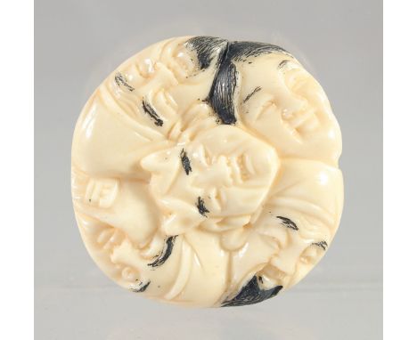 A CHINESE CARVED BONE FACES NETSUKE. 1.5ins
