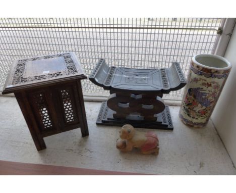 An Anglo Indian occasional table, African ebonised head rest, Chinese carved figure of a young boy and a Chinese stick stand