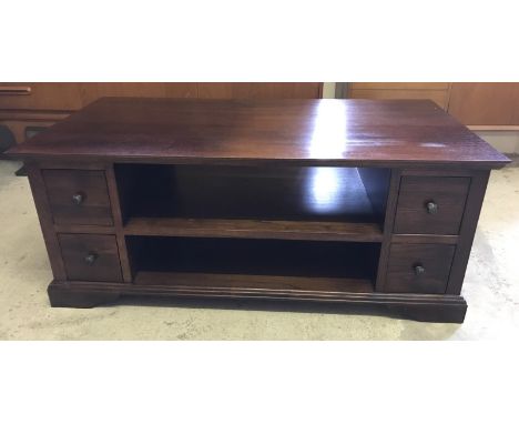 A dark oak double sided coffee table with 8 drawers and central shelf.  Approx 123 x63cm x 50cm tall.