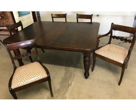 A Victorian dark oak wind out table together with 4 dark oak dining chairs and a matching carver. Table has original ceramic 