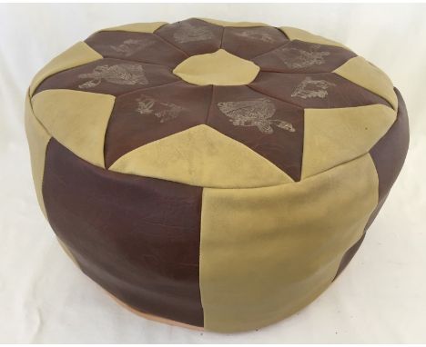 A c1970's leather pouffe. In buff & brown colour with gilt printed Arab lady and desert scene decoration to top. 