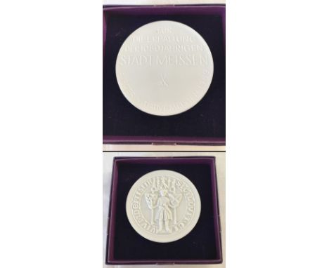 A boxed Meissen white bisque porcelain medallion. Marked to back with cross swords. 
