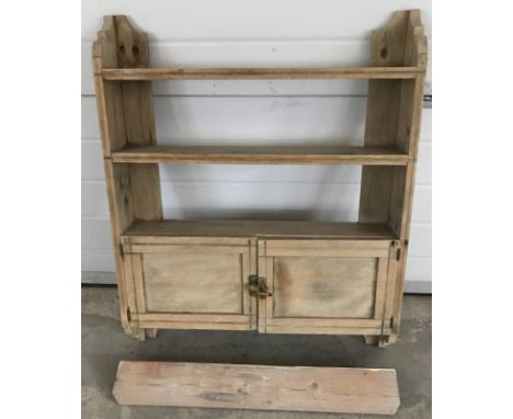 A vintage pine hanging shelf with 2 door cupboard.  Approx 69 cm wide x 84 cm tall.