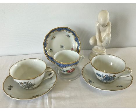 A small collection of ceramic items. Comprising Nymphenburg & Hutschenreuther cups and saucers and a figure in the style of P