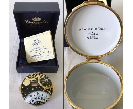 A painted enamel box by Crummles & Co. Boxed. Depicting time. 6cm diameter.