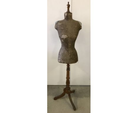 An Edwardian dress makers dummy. Wooden tripod stand. 154 cm tall approx.