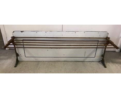 A large enamel backed vintage metal kitchen shelf. Collapsible shelf. Measures approx 109cm x 41 cm.