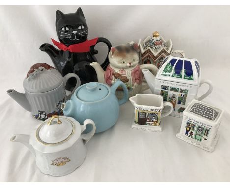 A collection of novelty ceramic collectors teapots. To include Wade teapot, milk jug and sugar bowl depicting village shops, 