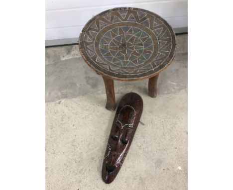 A vintage tribal bead decorated stool together with a wall hanging mask. Stool dated 1929, some beads missing. Crack to seat.