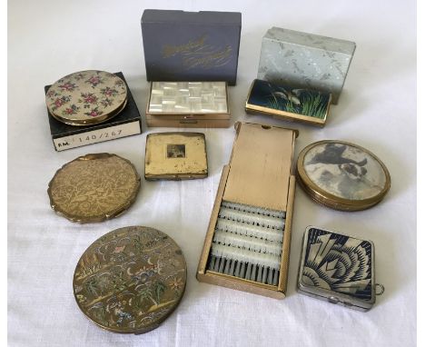 A collection of vintage compacts and ladies items. To include a boxed Clover musical compact, a boxed Kigu lipstick holder de
