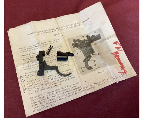 An FN Browning trigger assembly with instruction leaflet.  
