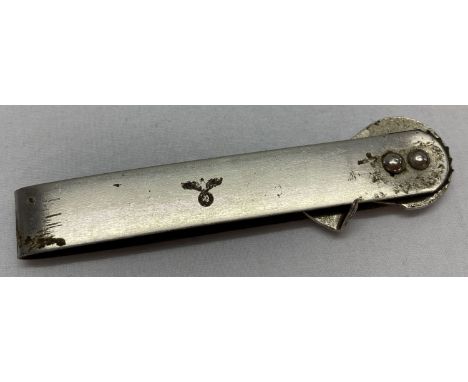 A WWII style German army can opener with engraved insignia.  