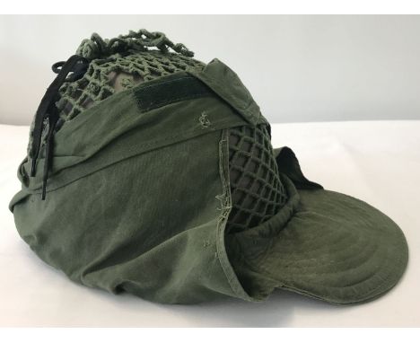 A 1937 pattern Swedish helmet with canvas and string peaked cover. Complete with canvas interior suspension lining and chin s