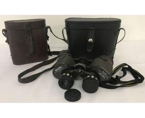 A cased pair of Miranda binoculars together with a vintage leather binoculars case. Miranda binoculars complete with lens cap