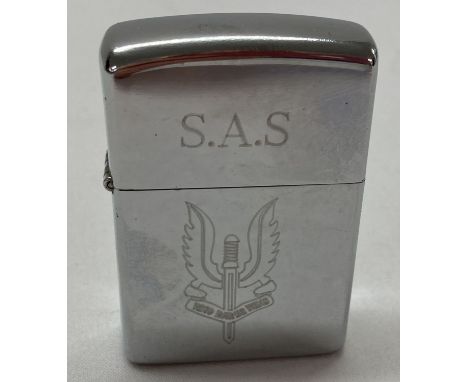 A chrome wind proof lighter engraved with SAS logo and motto.  