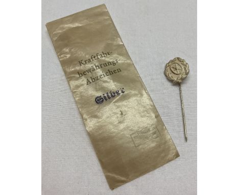 A WWII style German silver class drivers stick pin in wax paper packet.  Pin approx. 5cm long.