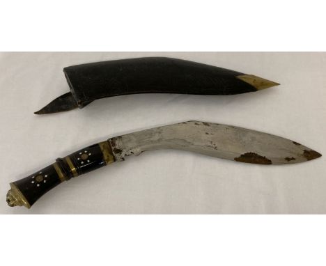 A vintage inlaid wooden handled Kukri with leather and brass scabbard. Brass banding to handle with lion head detail to end. 