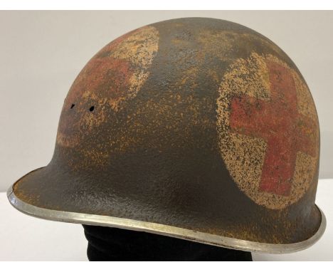 A WWII style semi relic US M1 front split seam swivel bale US medics helmet.  