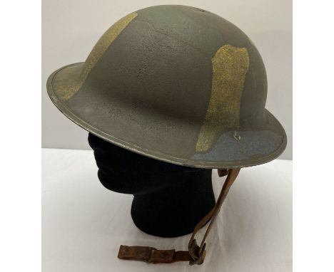 A WWI style American "Brodie" helmet with painted jigsaw pattern camouflage.  