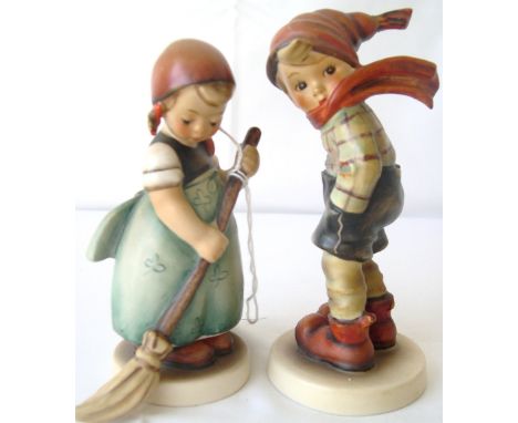 Two Goebel Hummel figures of a boy and girl.