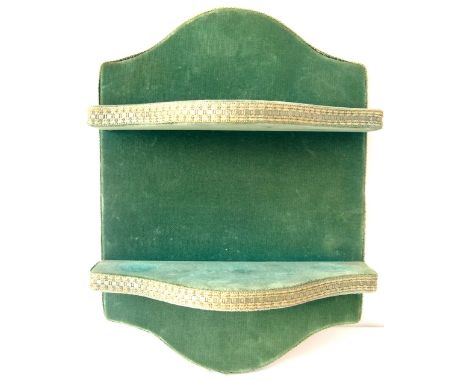 Small green velvet two-shelf wall bracket.