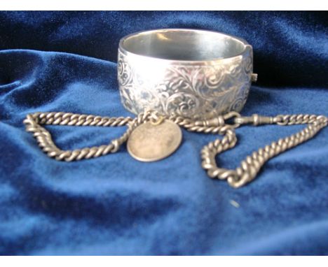 Silver fob chain with two dog clips and 1 franc coin mount and a silver bangle with scroll decoration, Birmingham 1946.   Con