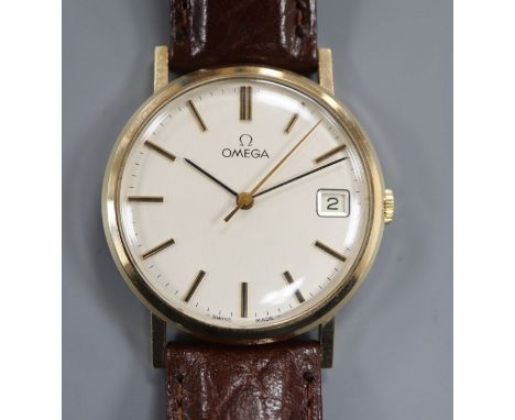 A gentleman's yellow metal Omega manual wind wrist watch, with date aperture, on later associated leather strap.