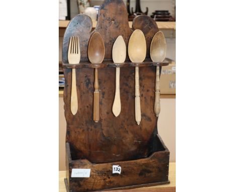 An 18th century fruitwood spook rack with turned carved spoons and fork