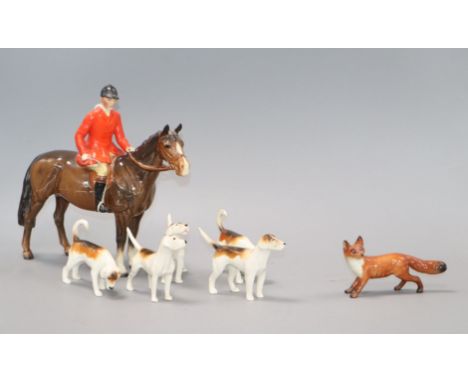 A Beswick fox hunting set including horse and huntsman, five hounds and a fox