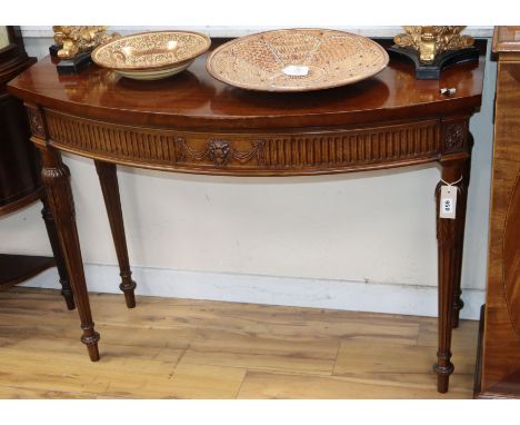 A George III style mahogany bow front console table W.110cm