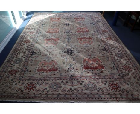 A Persian fawn ground carpet 380 x 276cm