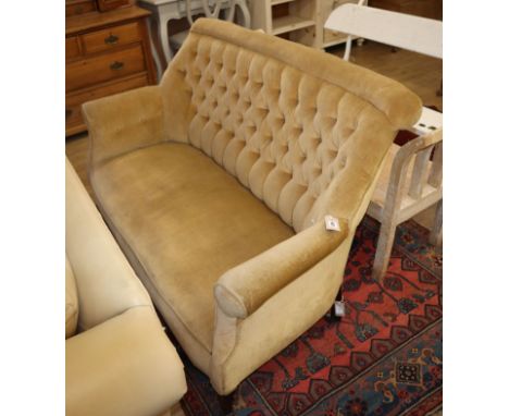 An Edwardian two seater sofa, upholstered in buttoned gold dralon