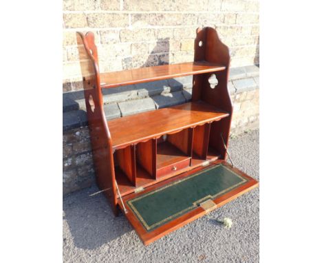 A VICTORIAN MAHOGANY HANGING WALL SHELF WITH FITTED SECRETAIRE with leather--lined fall flap 76cm wide (with key)