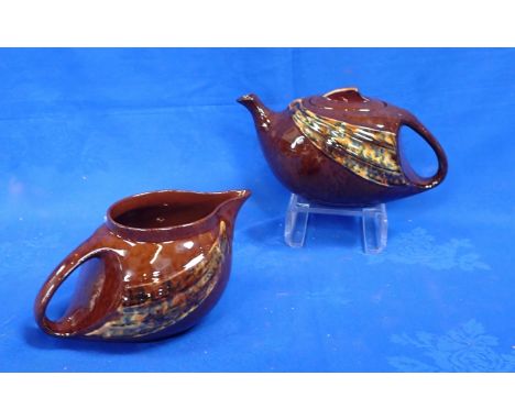 AN ART NOUVEAU STYLE BROWN TEAPOT AND MILK JUG (sold in aid of The Children's Society)